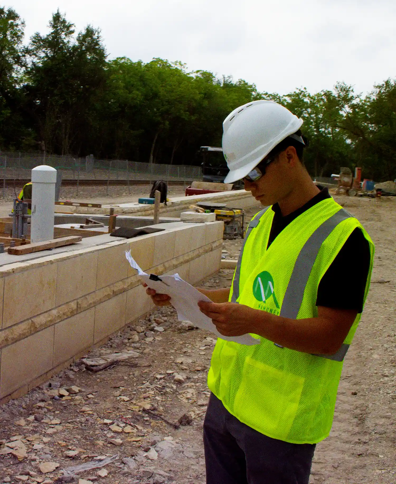 Civil Engineering advisory Engineer reviewing plans on site