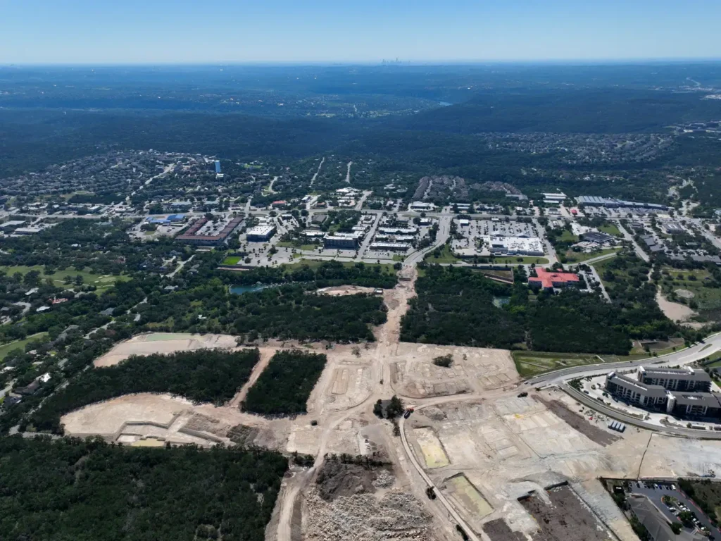 Home 1 St. Ambrose mixed-use development, Austin TX — high aerial view of large-scale site clearing and land planning