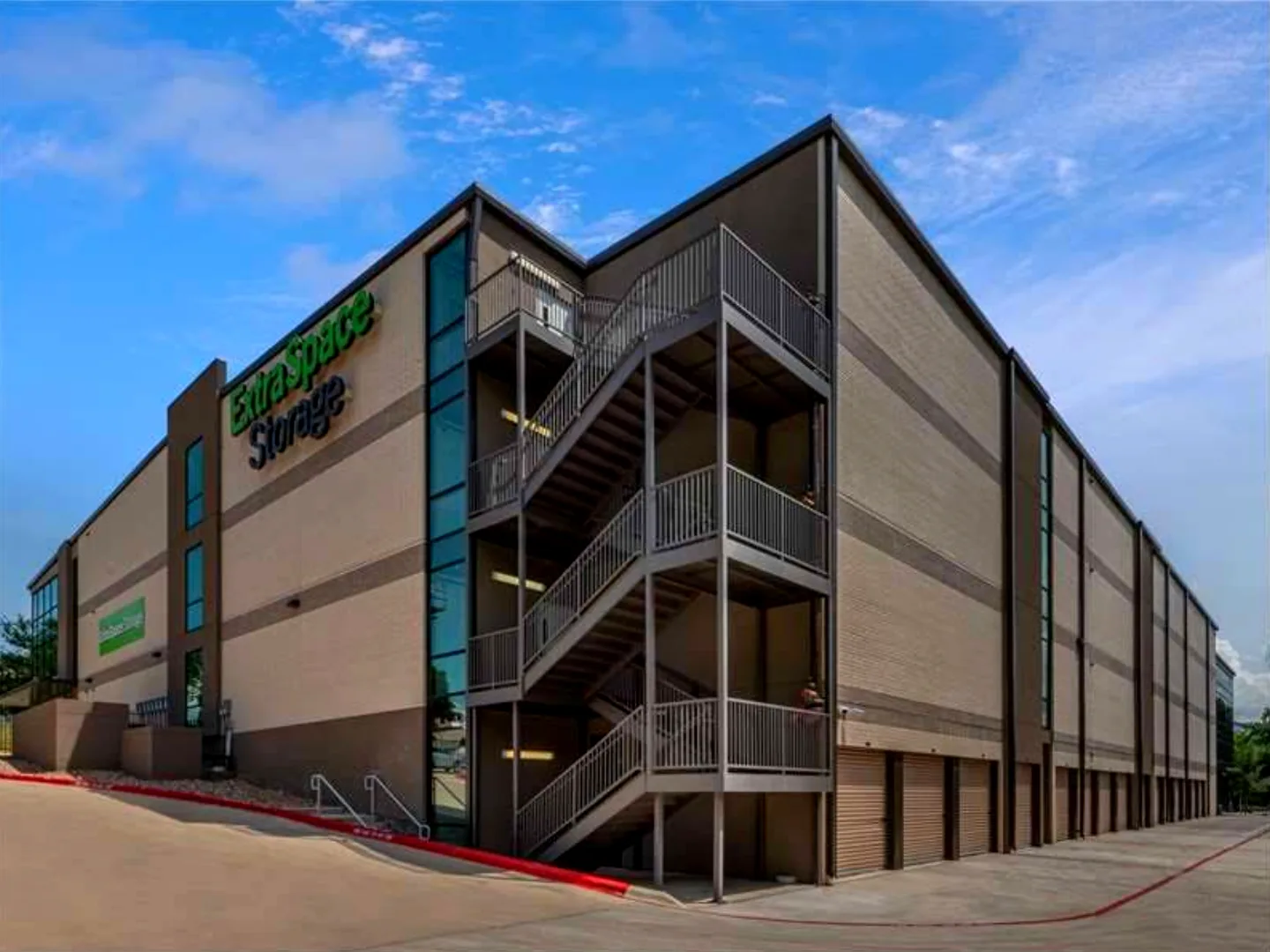 Four-story Extra Space Storage facility in Austin, Texas, with exterior steel stairs and drive-up units, supported by a Mahoney Engineering floodplain study